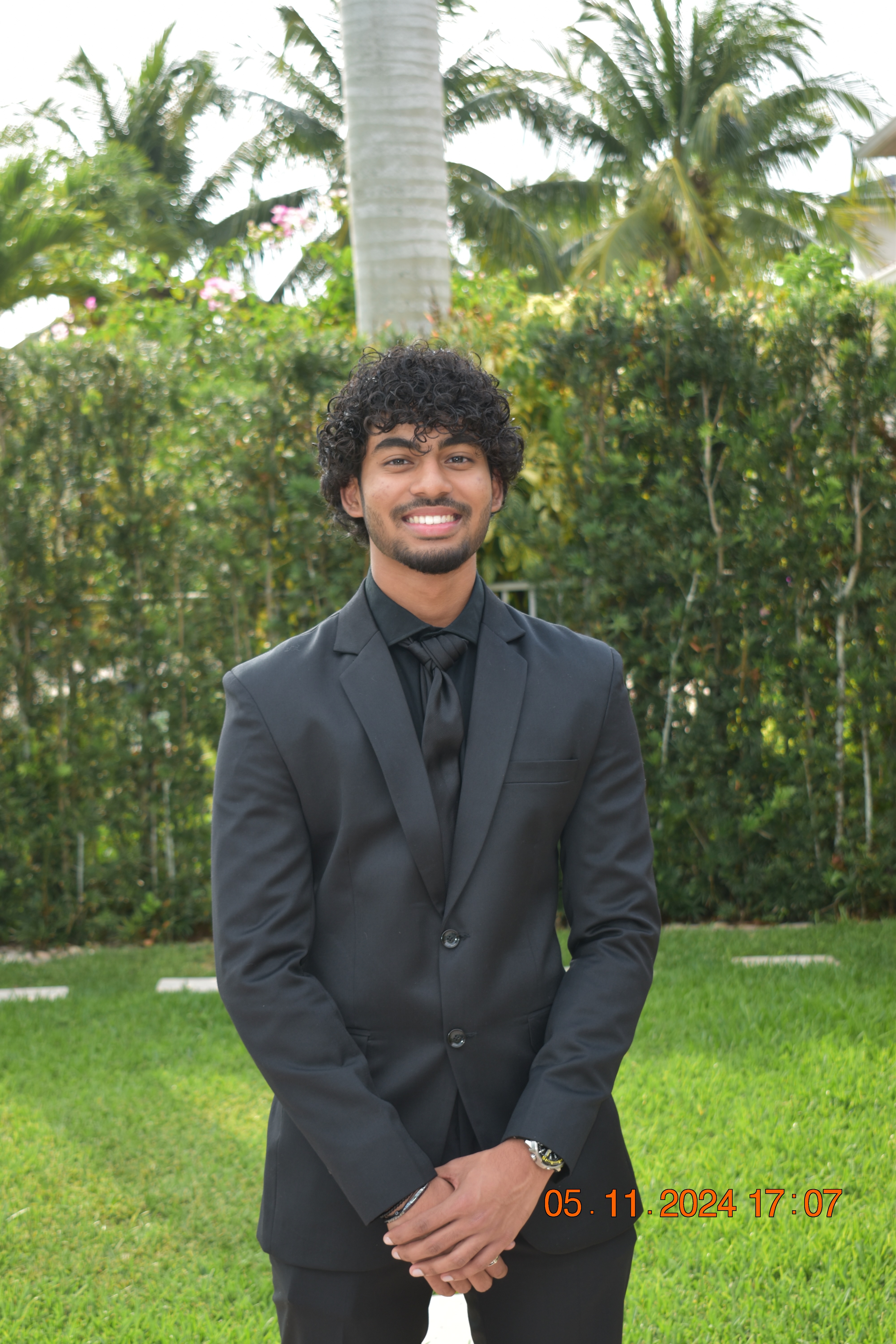 Arya Maran - Professional headshot in natural outdoor setting